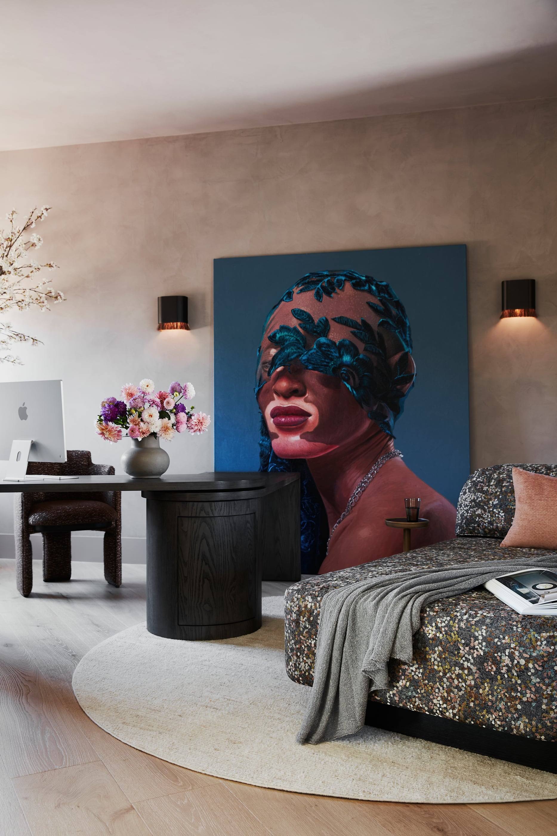 Lounge with a large portrait painting and a patterned chaise