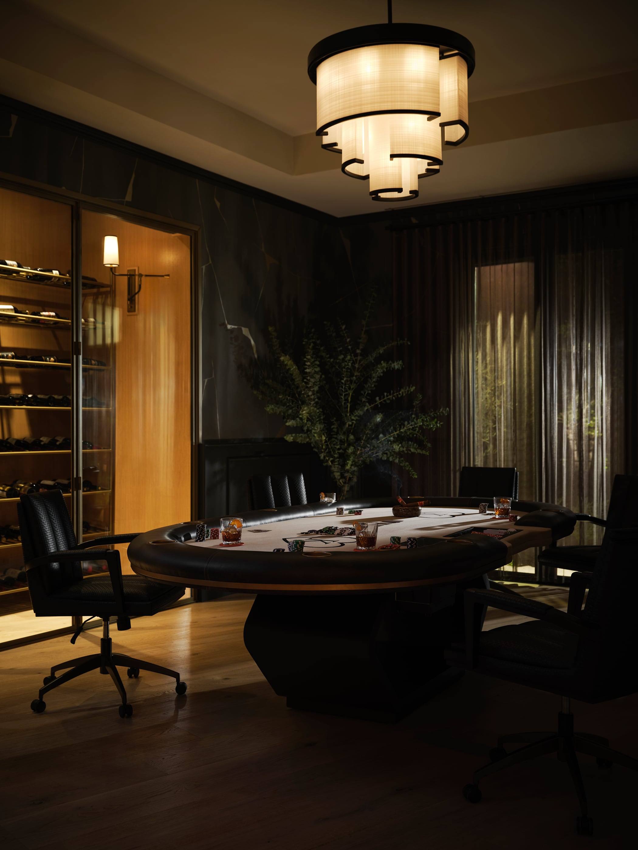 Card room with a round table beneath a tiered glass chandelier