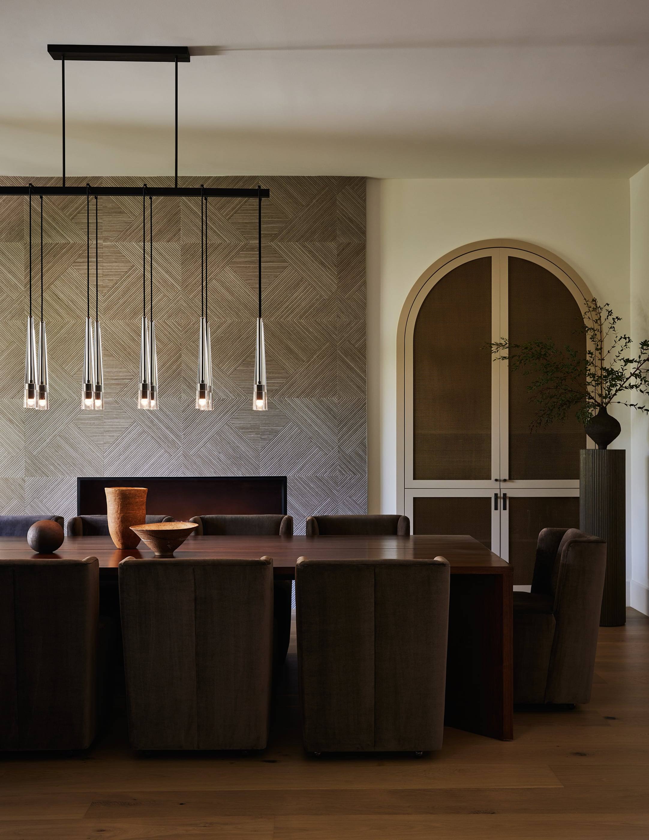 Dining room with arched cabinetry and a stone fireplace wall