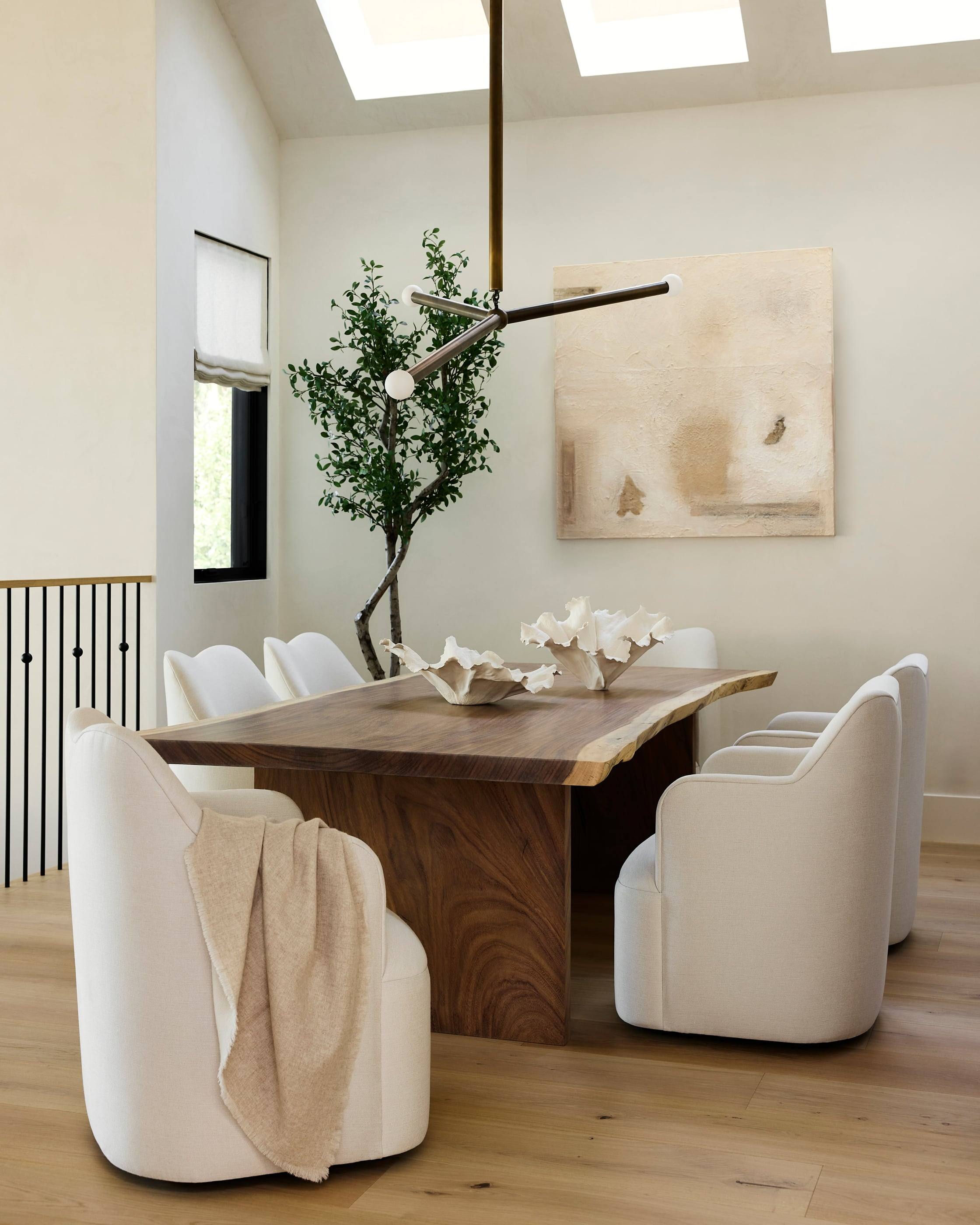 Dining room with a live-edge table and cream bouclé chairs