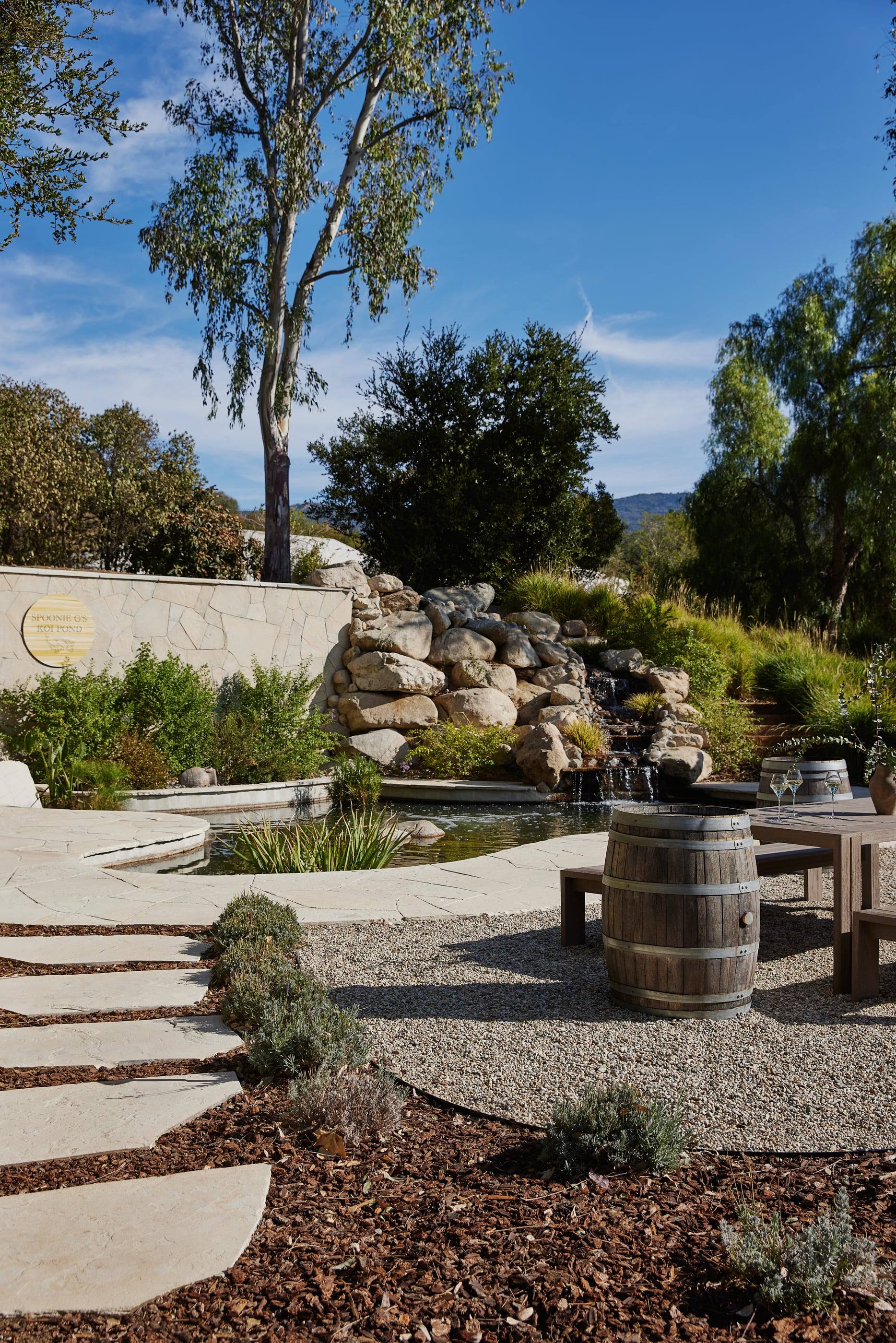 Stone path through a drought-tolerant garden to a firepit