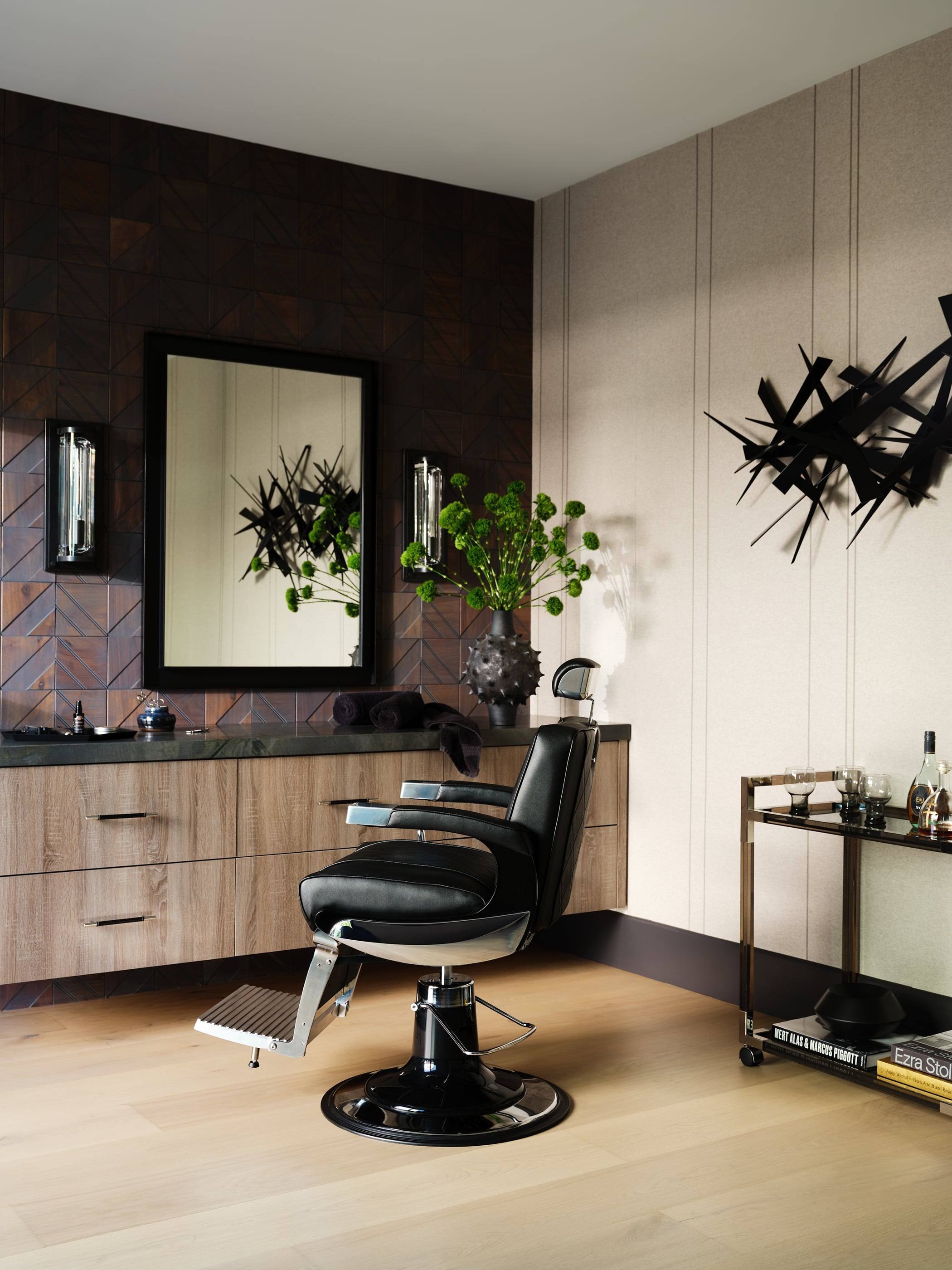 Private grooming room with a barber's chair and sculptural wall art