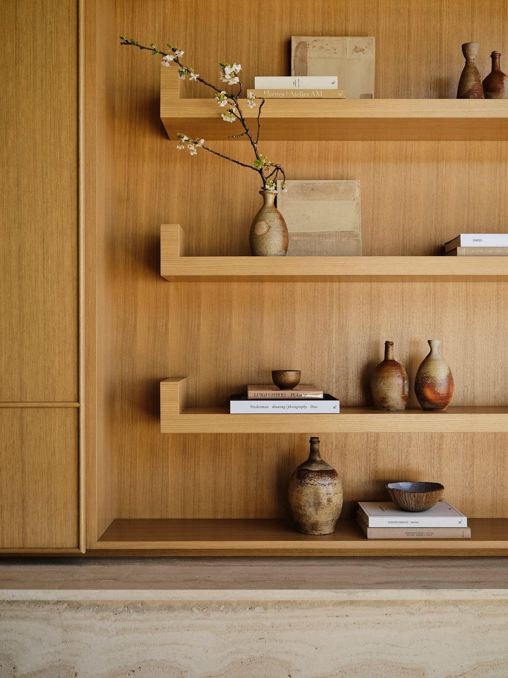 White oak shelving with stoneware vessels and books