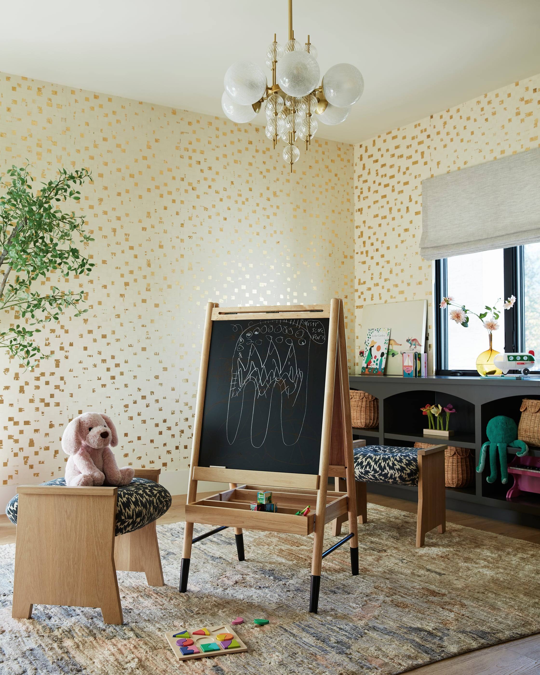 Playroom with gold-flecked wallpaper and a child's easel